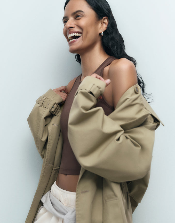 Smiling model in a brown organic tank with a tan oversized jacket – MATE the Label