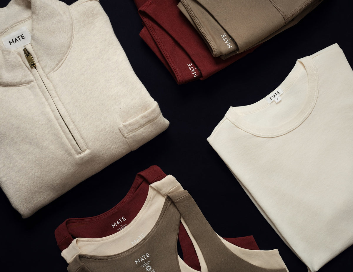 Folded cream half-zip, ivory tee and tanks in mulberry, cream and pebble – MATE the Label