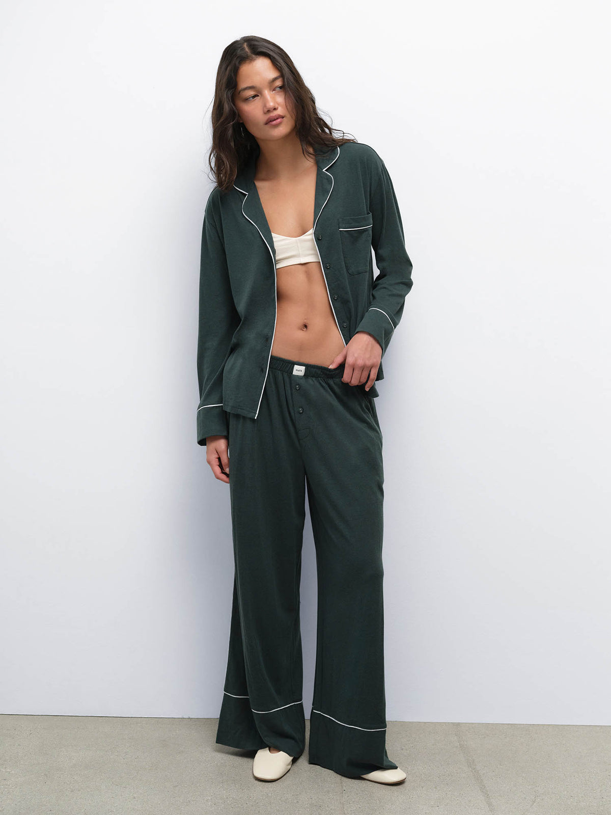 Model wearing the Tencel Sleep Set in Balsam with Heather Grey piping, shirt worn open over a bralette
