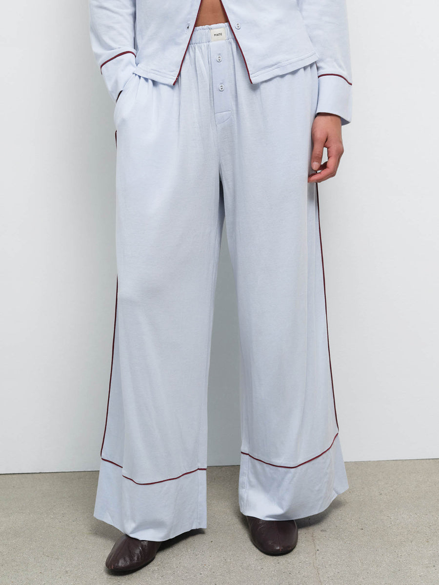 Close-up of the wide-leg pant from the Tencel Sleep Set in Powder with Garnet piping