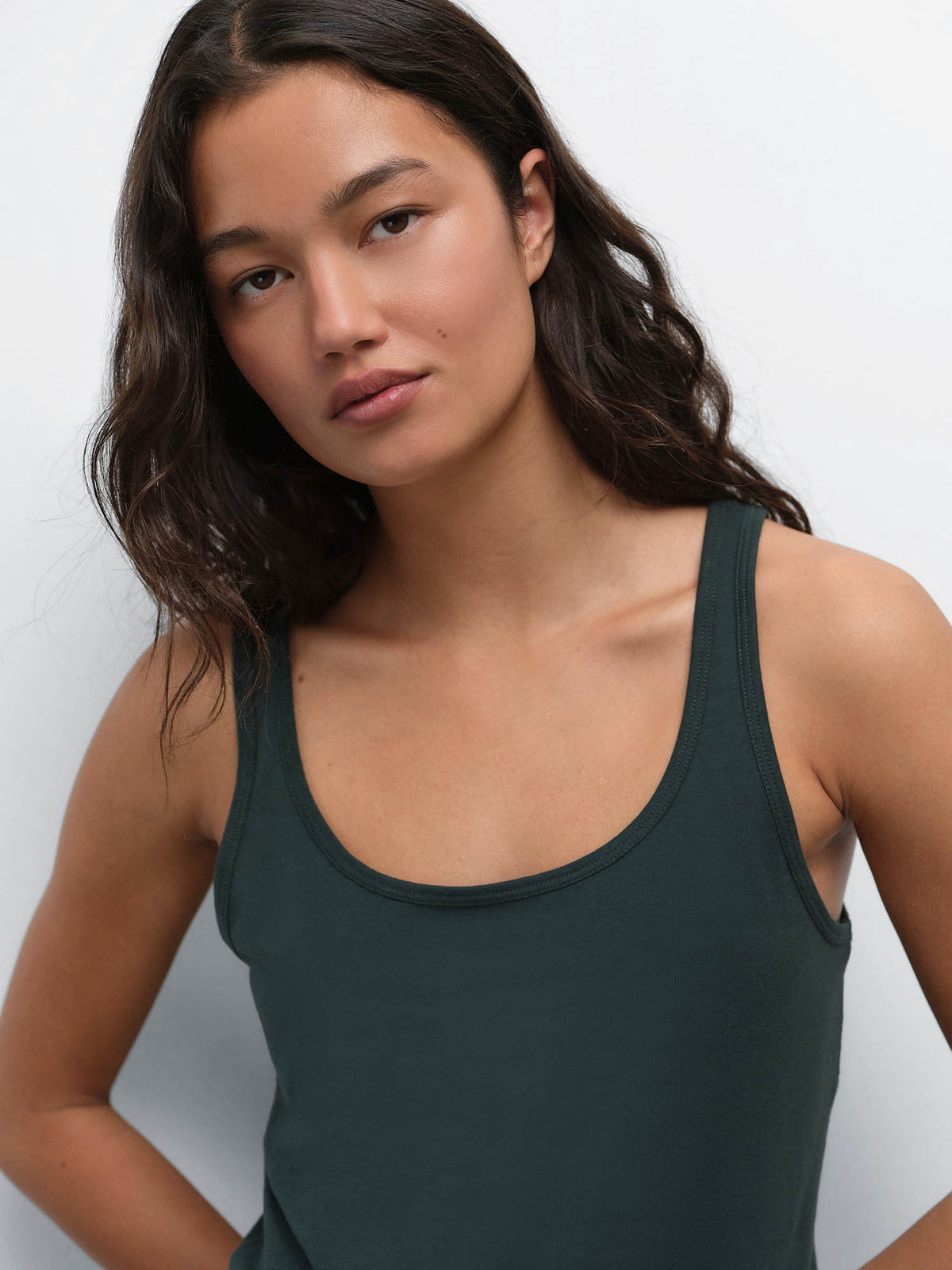 Close-up of model with hand on hip wearing the Tencel Sleep Scoop Tank in Balsam