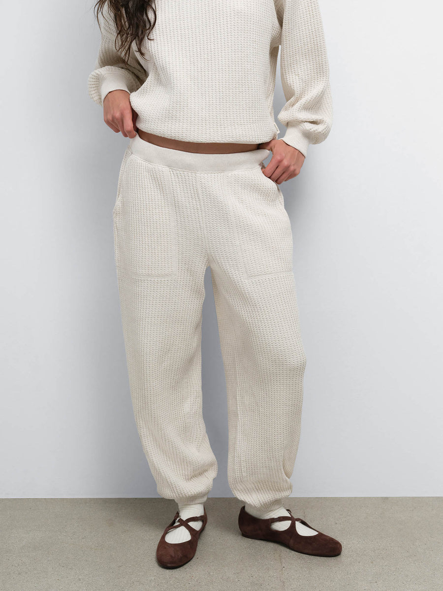 Close-up of the Organic Waffle Sweatpant in Oat worn with black Mary Jane flats