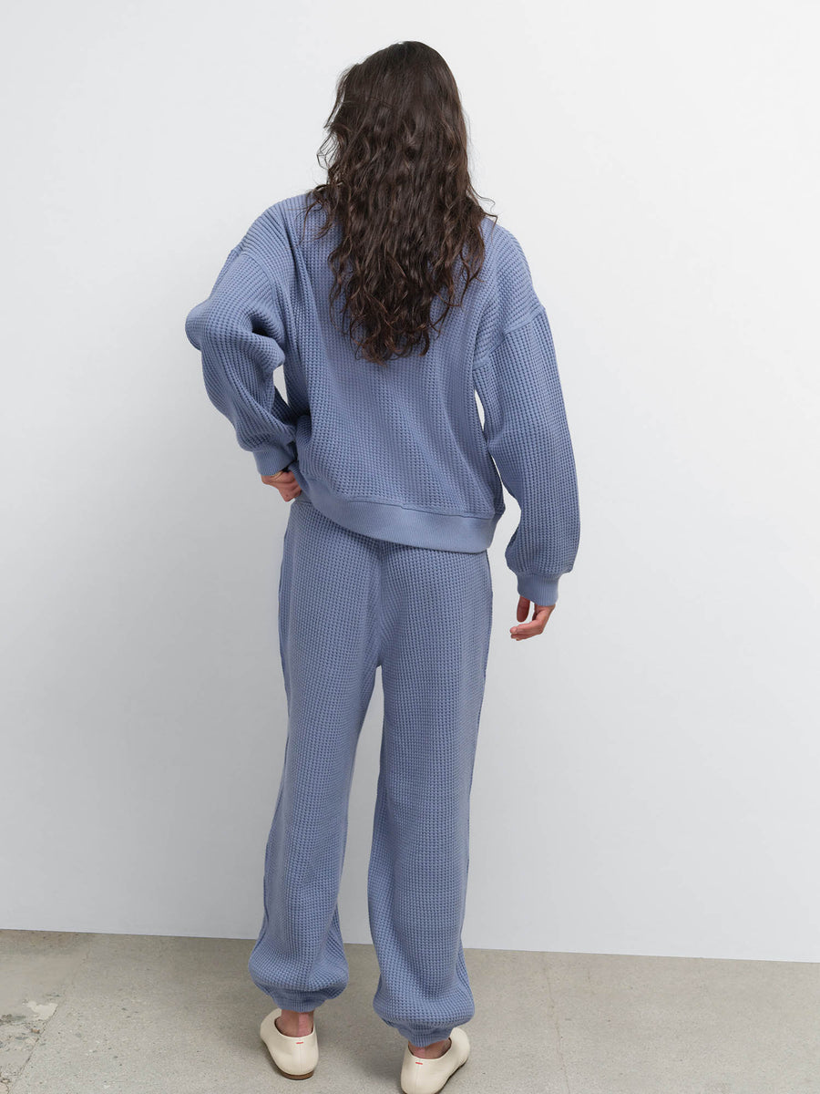 Back view of model wearing the Organic Waffle Crewneck Sweatshirt and Sweatpant in Bay