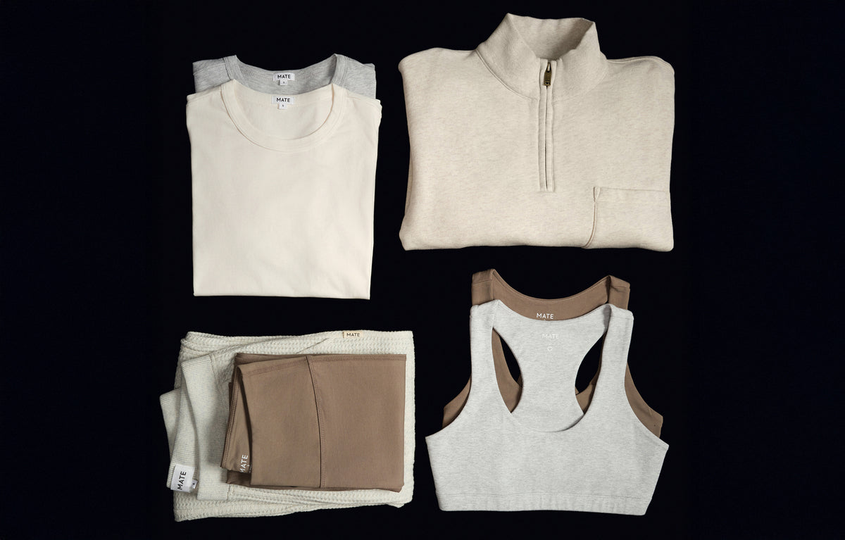 Cream sweatshirt, half-zip pullover, folded taupe bottoms and white bra on black – MATE the Label gift guide