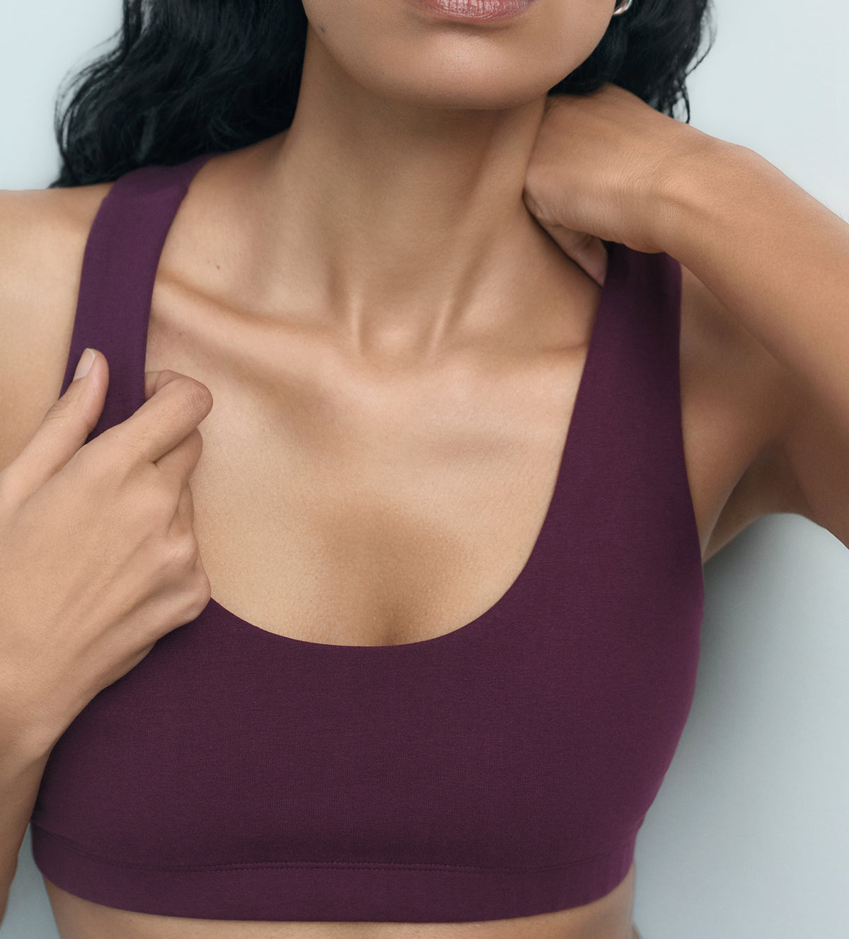 Detail of a fig purple organic stretch sports bra on model – MATE the Label activewear