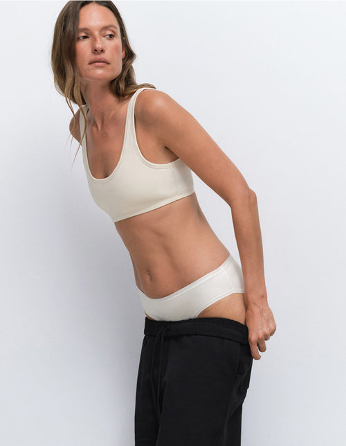 Model wearing a cream bra and underwear set from Mate the Label