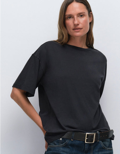 Model wearing an oversized black t-shirt from Mate the Label