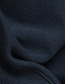 Organic Fleece fabric detail, showing the substantial knit surface and softly brushed interior.