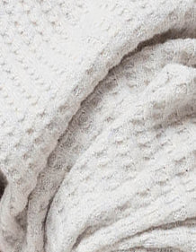 Organic Waffle fabric detail, showing the soft, raised waffle texture of organic cotton.